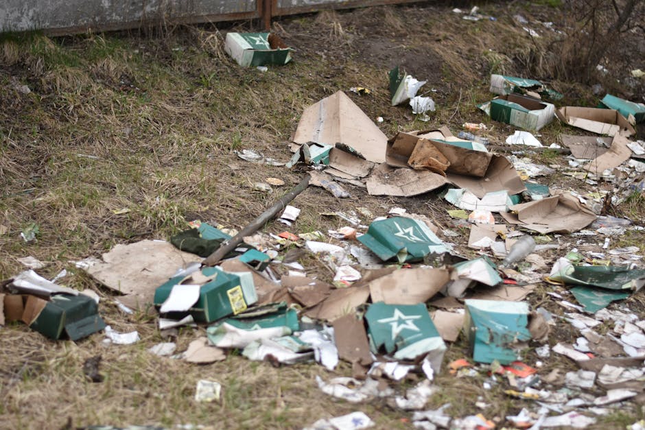 A crumpled and weathered crushed aluminium can of Classic Cherry Coca-Cola, featuring the iconic red and white branding with the Coca-Cola logo prominently displayed, lies on dark, rocky ground compos